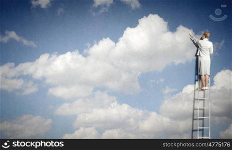Back view of businesswoman standing on ladder and reaching to cloud. Computing concept