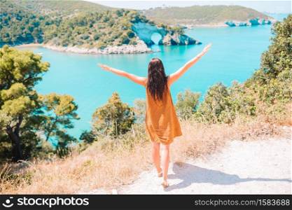 Back view of girl on the background of the cliff. Girl on vacation travel background beautiful landscape