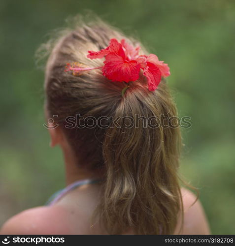 Back view of ponytail with a flower