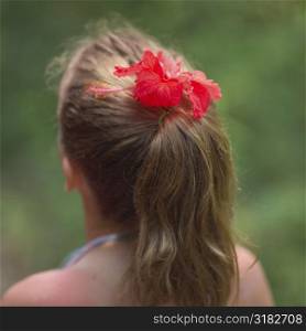 Back view of ponytail with a flower