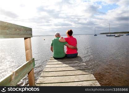 Back view of senior couple sitting on a pontoon