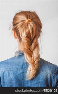 back view of the blond haired female with braid (pigtale), head and shoulders shot