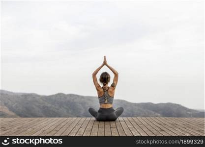 Back view of woman doing yoga outdoors Picture on pik. Resolution and high quality beautiful photo. Back view of woman doing yoga outdoors Picture on pik. High quality beautiful photo concept
