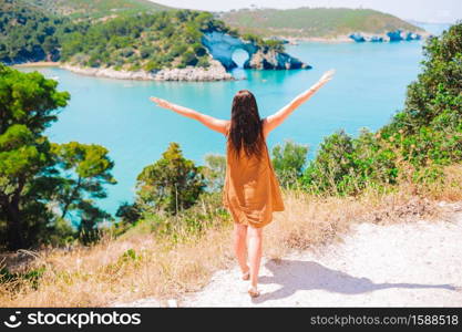 Back view of woman on summer vacation on beautiful coast in Europe. Girl on vacation travel background beautiful landscape