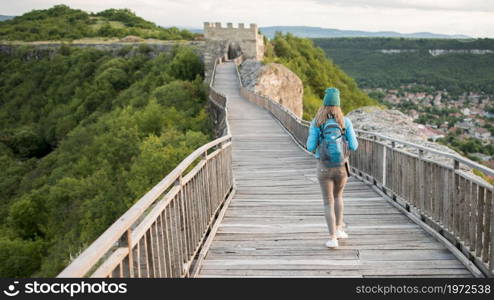 back view traveller walking down bridge. High resolution photo. back view traveller walking down bridge. High quality photo