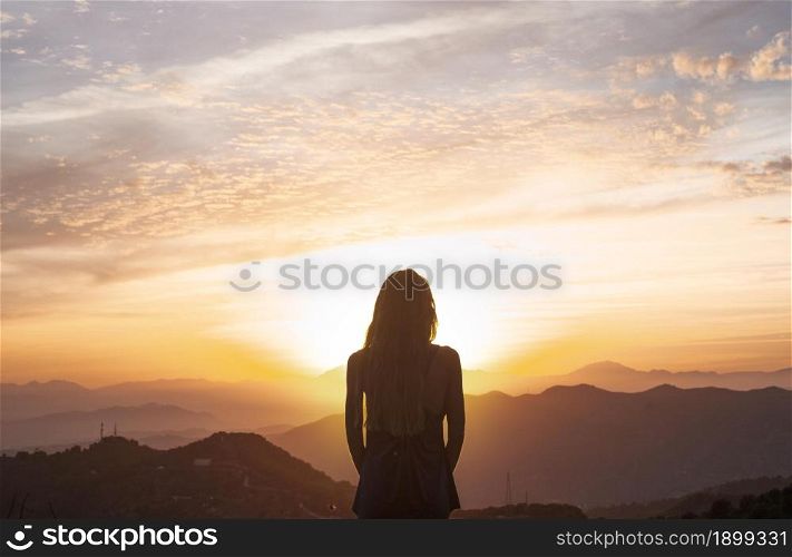 back view woman doing yoga while watching sunset. Resolution and high quality beautiful photo. back view woman doing yoga while watching sunset. High quality beautiful photo concept