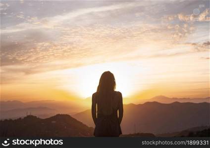back view woman doing yoga while watching sunset. Resolution and high quality beautiful photo. back view woman doing yoga while watching sunset. High quality beautiful photo concept