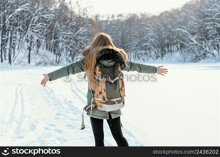 back view woman with backpack winter day