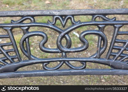 backed by a beautiful iron bench