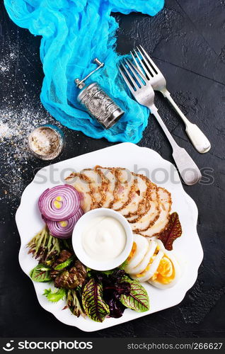 backed chicken fillet with white sauce on plate