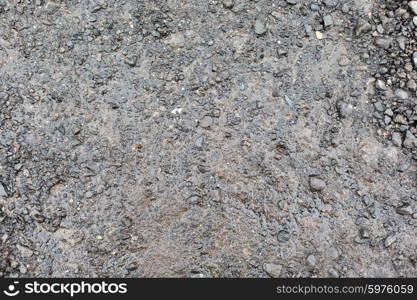 background and texture concept - close up of wet gray gravel road or ground. close up of wet gray gravel road or ground