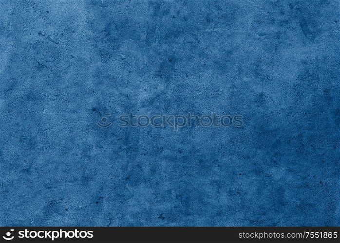 background and texture concept - concrete wall painterd in classic blue color of the year 2020. concrete wall painterd in classic blue color