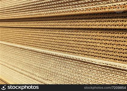 Background and texture of a stack of packaging cardboard in the sun.