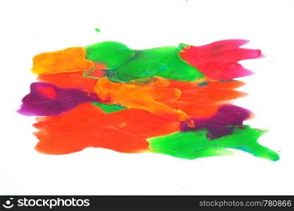 Background and texture of multi-colored neon strokes of plasticine on a white background.