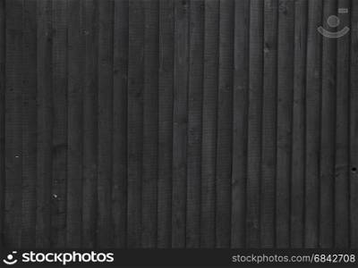 background black stained wooden planks on fencing or barn