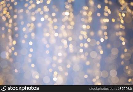 background, bokeh, holidays and backdrop concept - blue and yellow blurred christmas lights