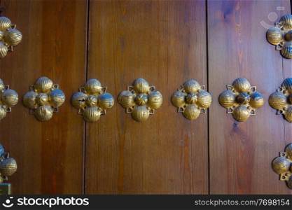 background brass hardware on old wooden door