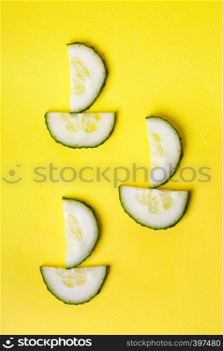 background - cheerful vegetables. boats from cucumbers on a yellow background.