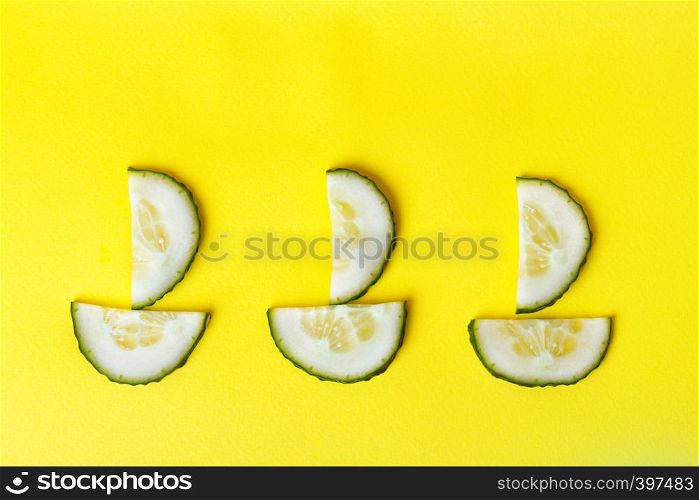 background - cheerful vegetables. boats from cucumbers on a yellow background.