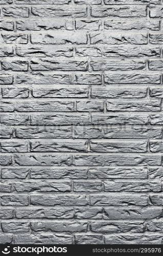 background consisting of part of silver or grey coloured brick wall
