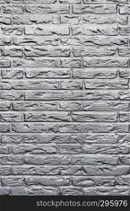 background consisting of part of silver or grey coloured brick wall