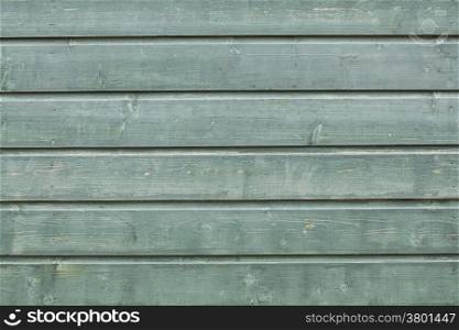 background consisting of part of weathered blue-ish green boards