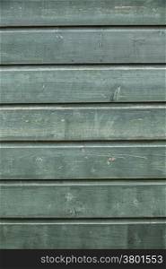 background consisting of part of weathered blue-ish green boards