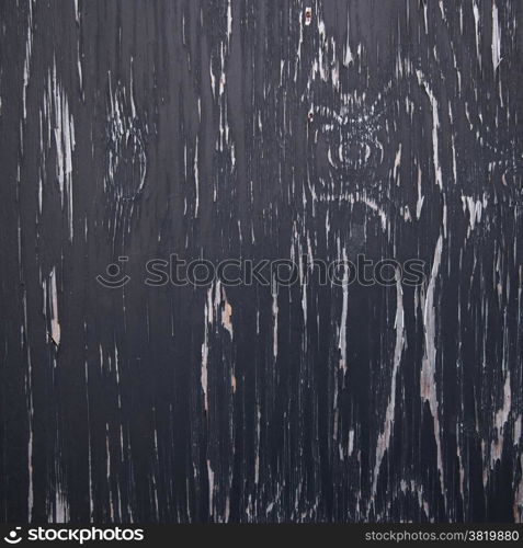 background consisting of wood with pattern of black peeling paint