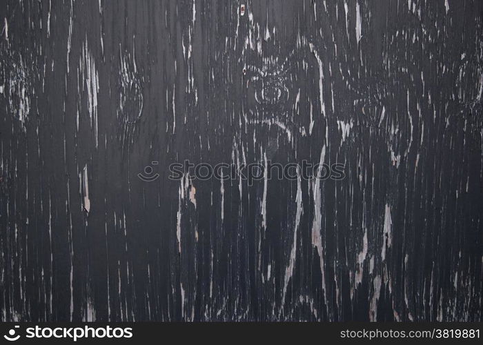 background consisting of wood with pattern of black peeling paint