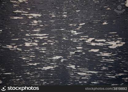 background consisting of wood with pattern of black peeling paint