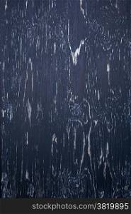 background consisting of wood with pattern of blueish black peeling paint