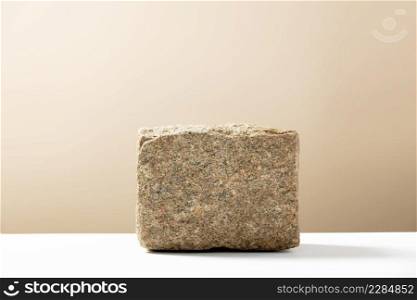 Background for cosmetic products of natural beige color. Stone podium. Front view