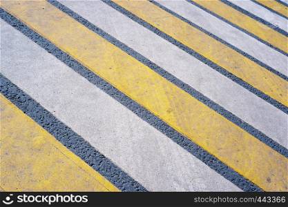 Background from a multi-colored pedestrian crossing. crosswalk on a asphalt road