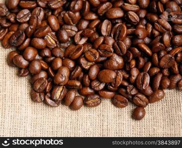 Background from coffee beans on fabric closeup