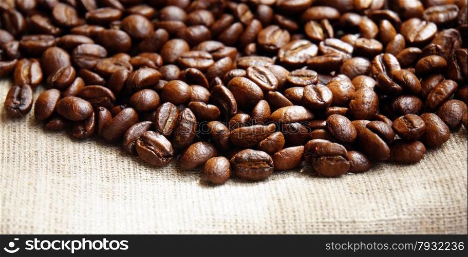 Background from coffee beans on fabric closeup