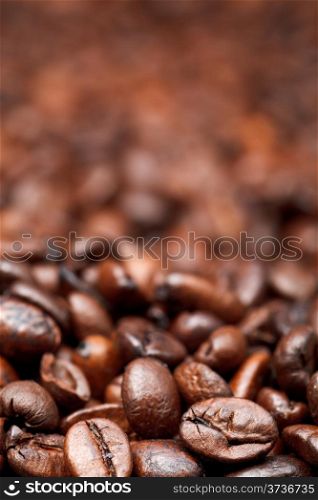 background from many roasted coffee beans with focus foreground