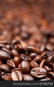 background from many roasted coffee beans with focus foreground