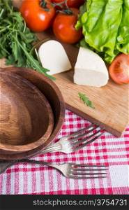 background from mixed vegetables with wooden board
