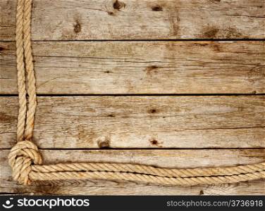 Background from old boards with rough rope
