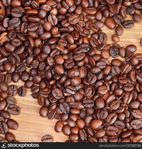background from roasted coffee beans close up on wooden board