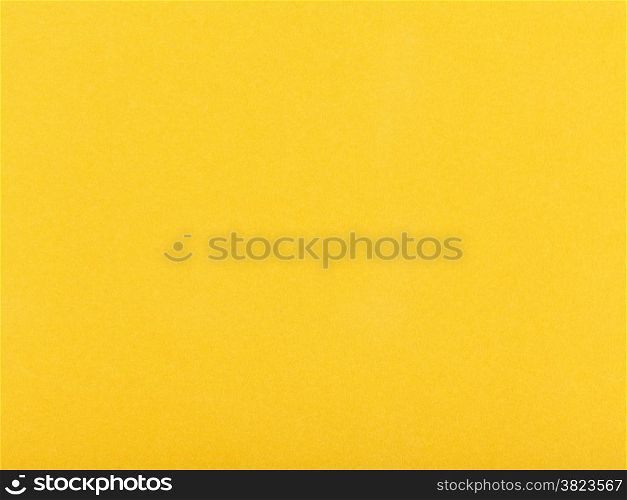 background from sheet of dark yellow color velvet paper close up