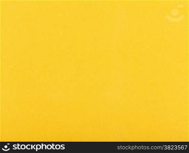 background from sheet of dark yellow color velvet paper close up
