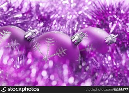 background from violet christmas balls with tinsel