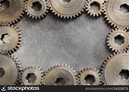Background image made of steel and old cog wheels.