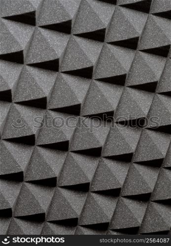 Background image of recording studio sound dampening acoustical foam.