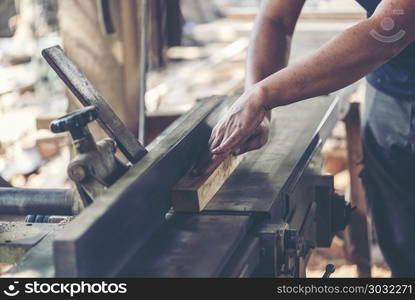 Background image of woodworking workshop: carpenters work table with different tools and wood cutting stand, vintage filter image