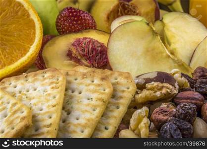 Background image with snacks, healthy fruits and nutritious nuts and crackers.