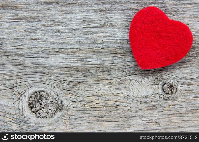Background in the style of Valentine&rsquo;s Day. Red heart on a wooden background