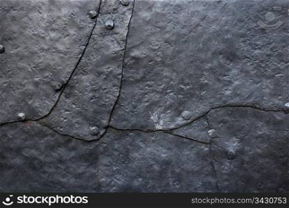 Background/industrial image of hammered metal plates with old rivets.
