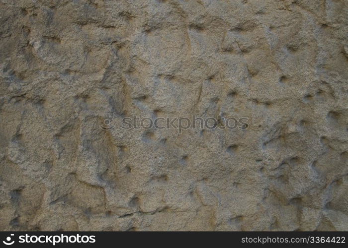 background jagged sandstone wall. background or texture of a jagged sandstone wall